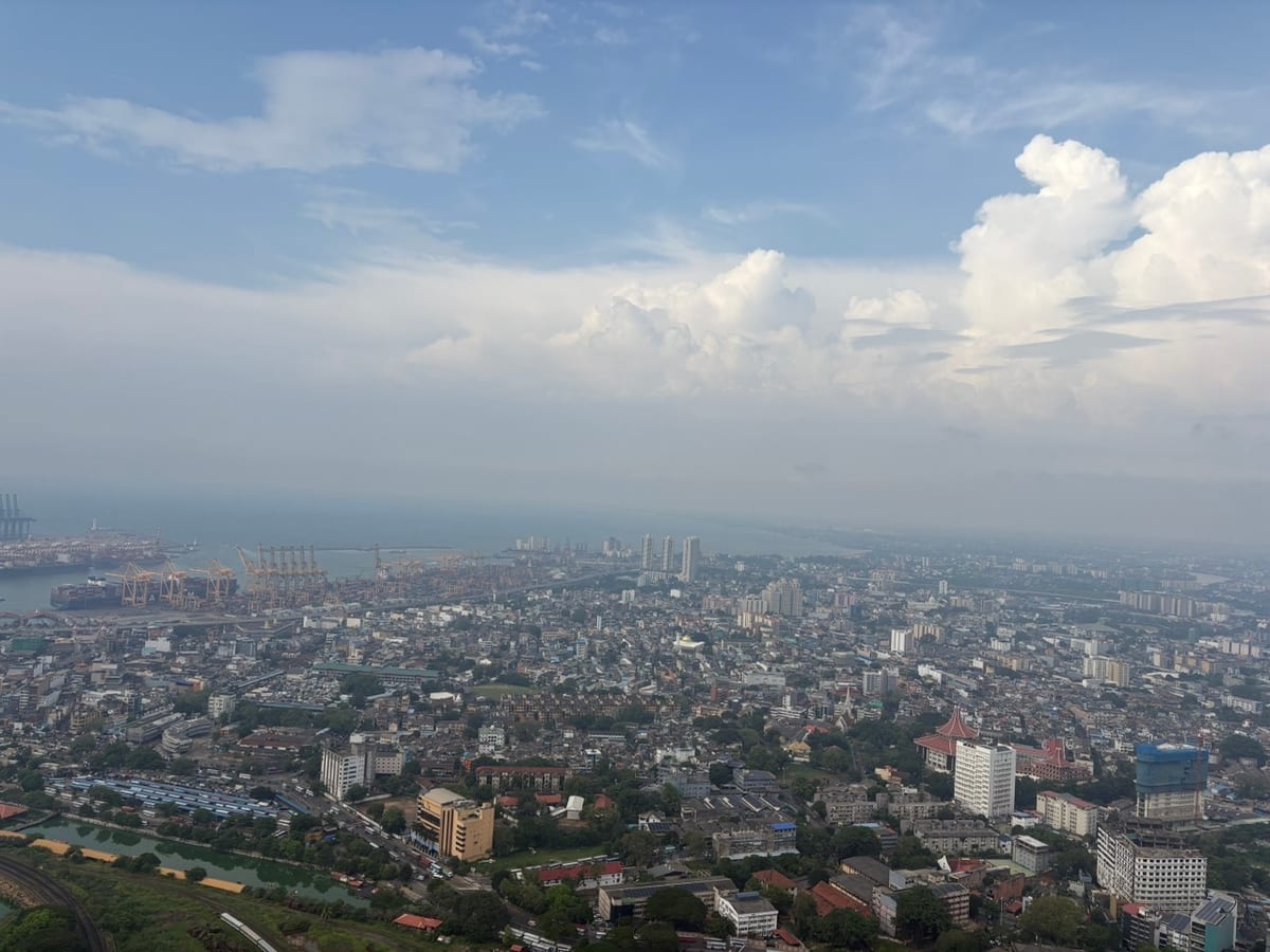 A high view across the rooftops of Colombo towards the harbour and the sea beyond