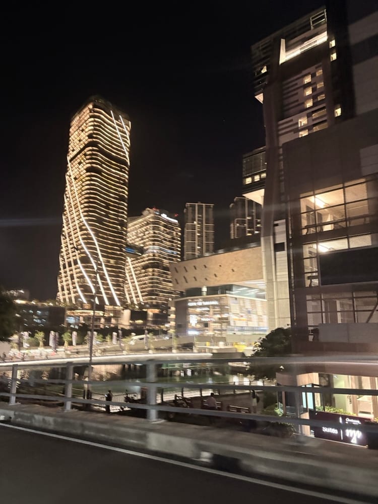 Curved high-rise towers on the Colombo waterfront lit up against the night sky